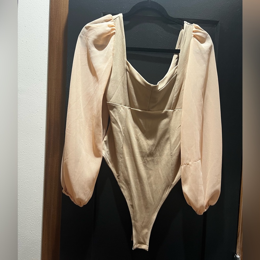 Tan bodysuit with mesh sleeves